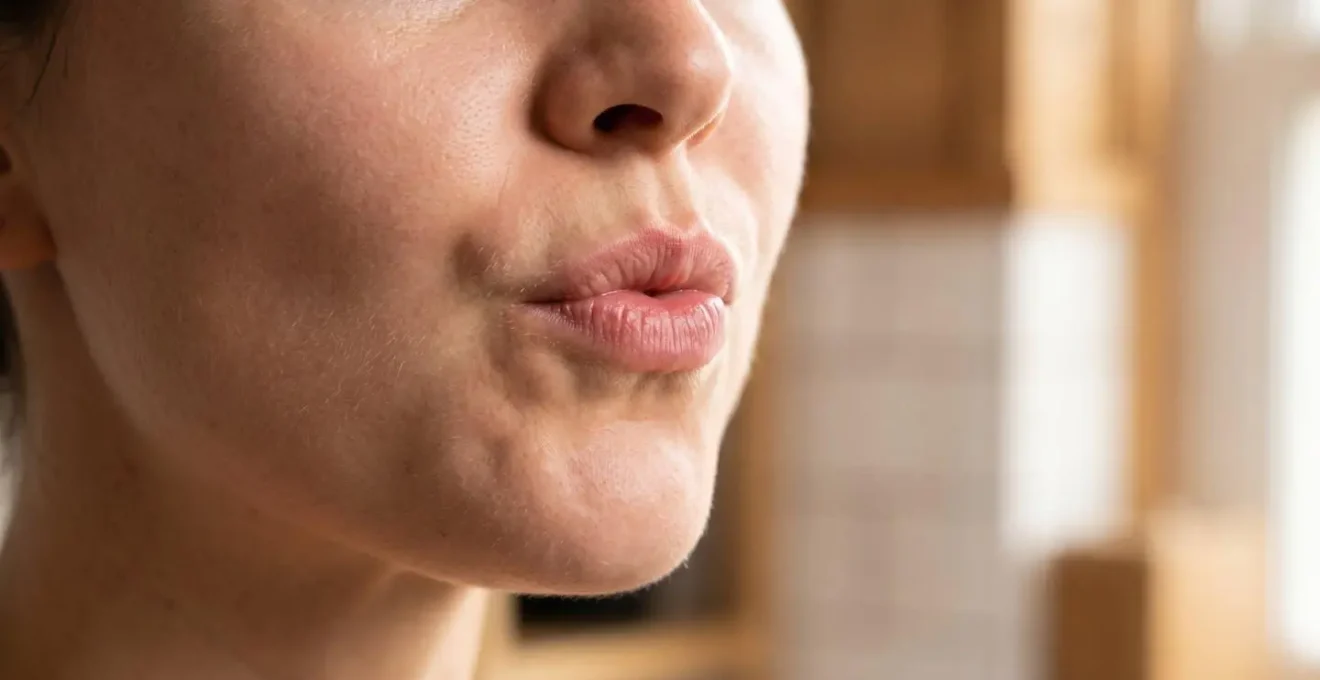 Close-up of person performing oil pulling technique showing proper jaw positioning