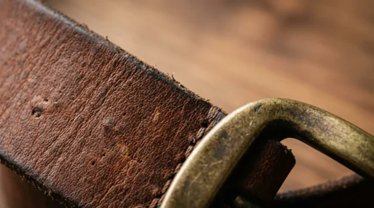 High-quality leather belt with visible grain texture and brass buckle